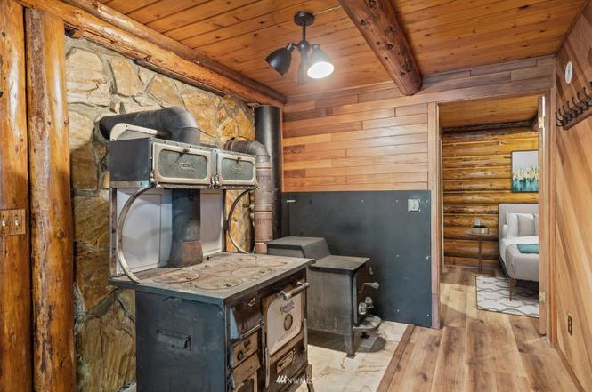 Rustic cabin utility nook with vintage stove detail