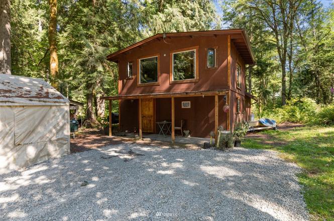 STR casita woodland retreat exterior with covered porch and forest surroundings