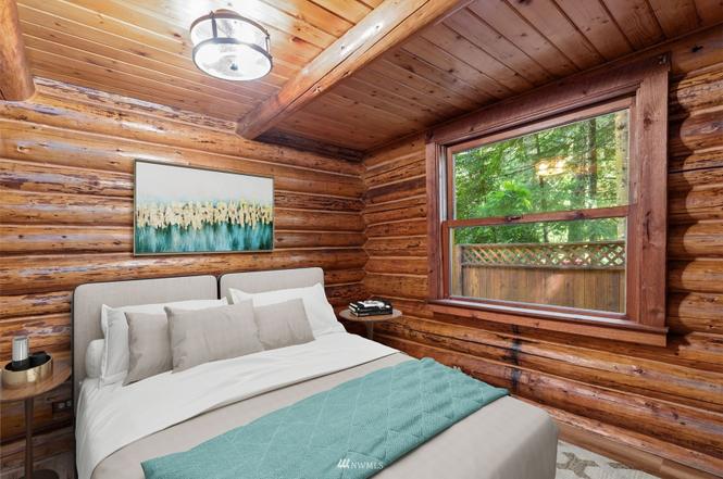 Guest bedroom with wood walls and garden views