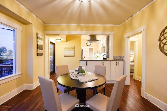 Dining room opening to a renovated kitchen with pass-through