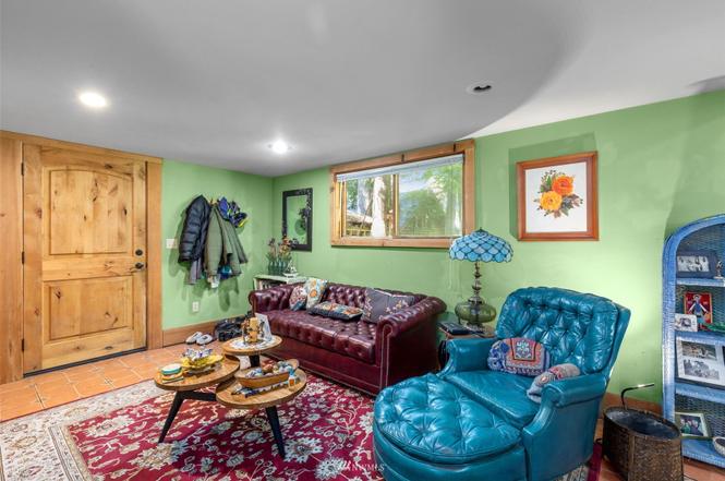 Cozy casita sitting area with green walls, leather seating, and natural light
