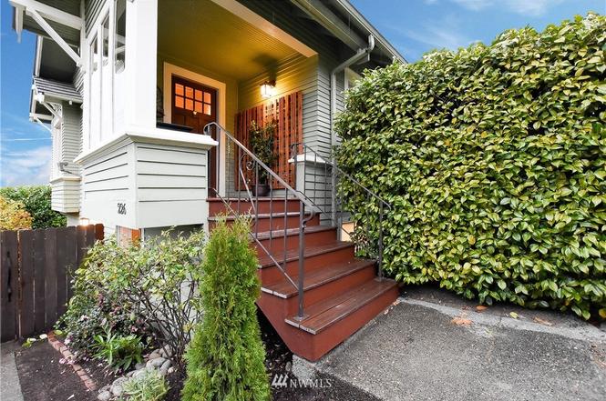 Craftsman home entry with covered porch and landscaped walkway
