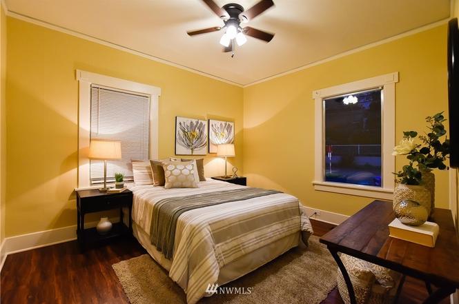 Guest bedroom with warm finishes and ceiling fan