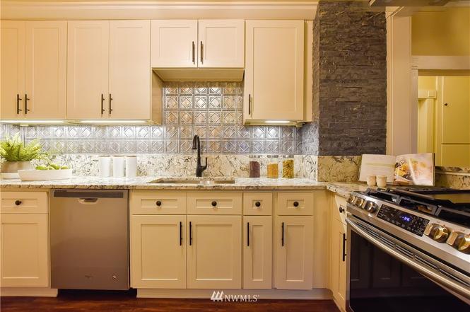 Kitchen detail with pressed-tin backsplash and stone accent wall